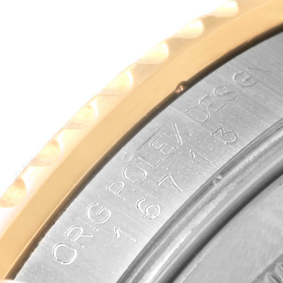 This close-up image shows the engraved side of a Rolex GMT-Master 16713 Men's Stainless Steel Black Dial 16713 Men's Stainless Steel Black Dial watch with part of the bezel visible.