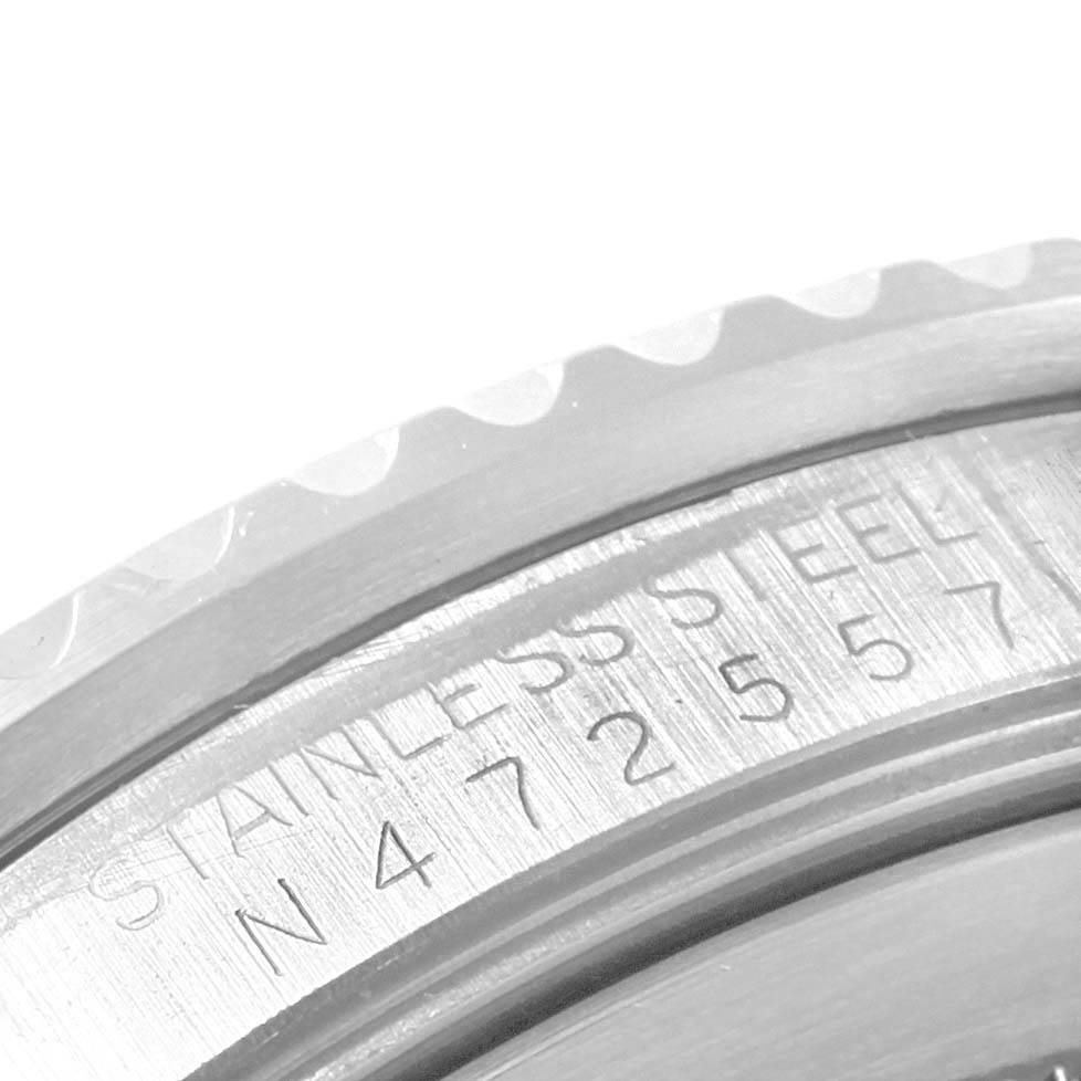 The image shows a close-up of the stainless steel bezel and serial number on a Rolex GMT-Master 16700 Men
s Stainless Steel Black Dial 16700 Men
s Stainless Steel Black Dial watch.