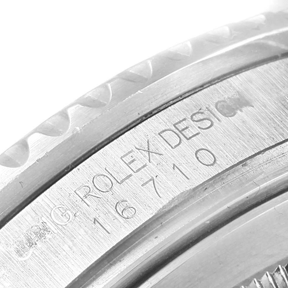 The image shows a close-up of the model number "16710" and "ORIG ROLEX DESIGN" engraving on a Rolex GMT-Master 16710 Men's Stainless Steel Black Dial 16710 Men's Stainless Steel Black Dial watch case.