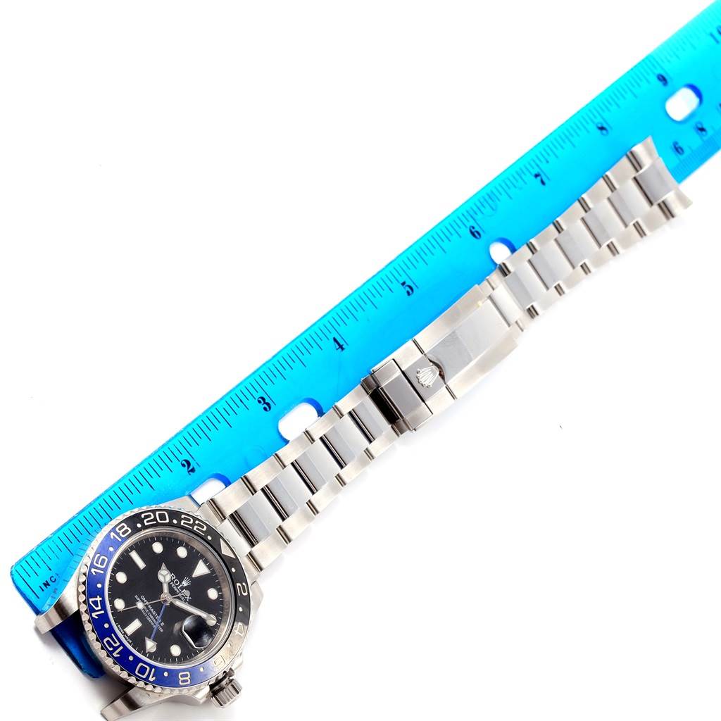 This image shows a Rolex GMT-Master 116710 Men's Stainless Steel Black Dial 116710 Men's Stainless Steel Black Dial watch laid flat, alongside a ruler, displaying the watch face and bracelet.