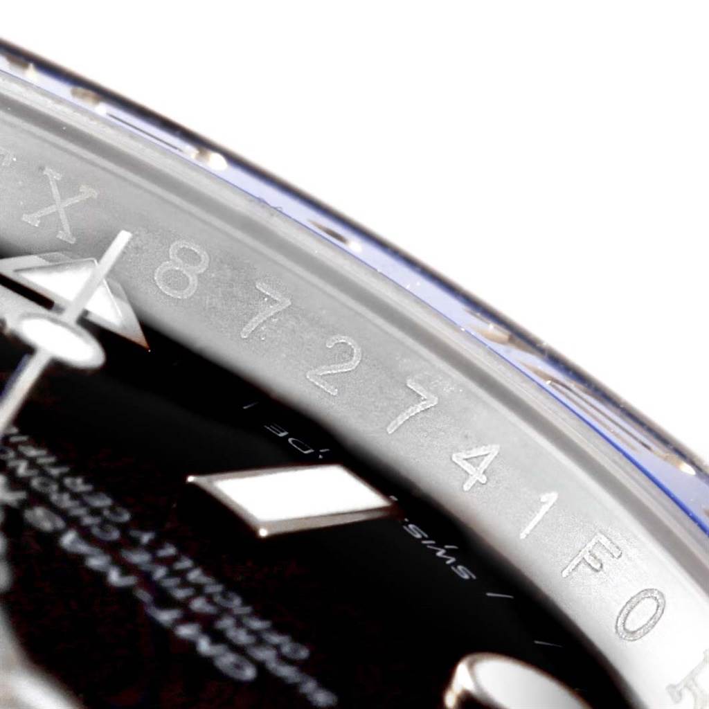 This close-up angle shows the engraved serial number and part of the dial for the Rolex GMT-Master 116710 Men's Stainless Steel Black Dial 116710 Men's Stainless Steel Black Dial watch.