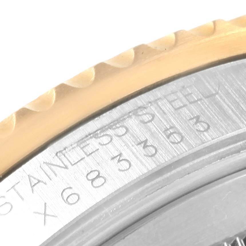 The image shows a close-up of the matching case back and bezel of a Rolex GMT-Master 16713 Men
s Stainless Steel Black Dial 16713 Men
s Stainless Steel Black Dial, highlighting the engraved text and part of the bezel
s edge.