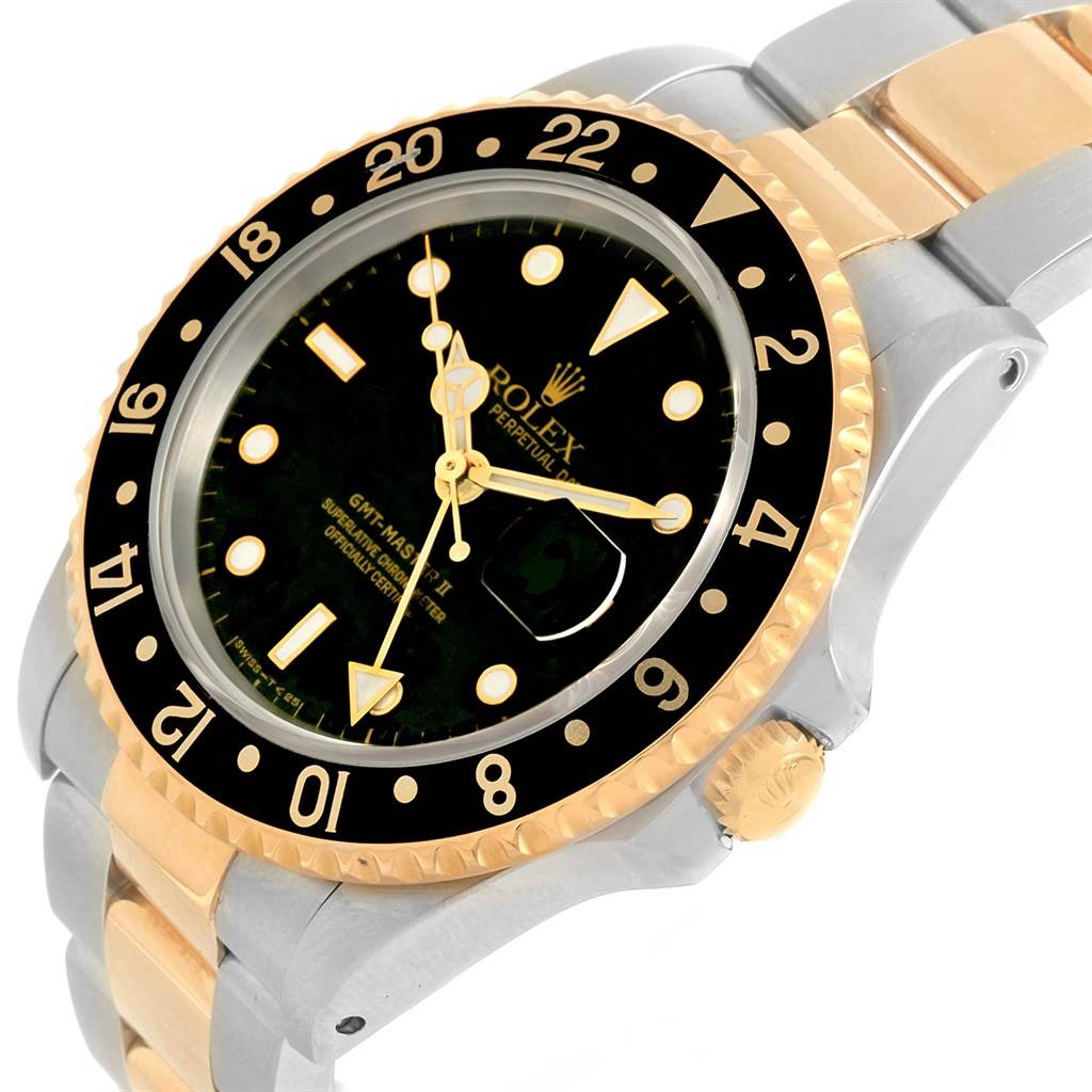 The Rolex GMT-Master 16713 Men
s Stainless Steel Black Dial 16713 Men
s Stainless Steel Black Dial watch is pictured at an angle, showcasing the bezel, crown, dial, and part of the bracelet.