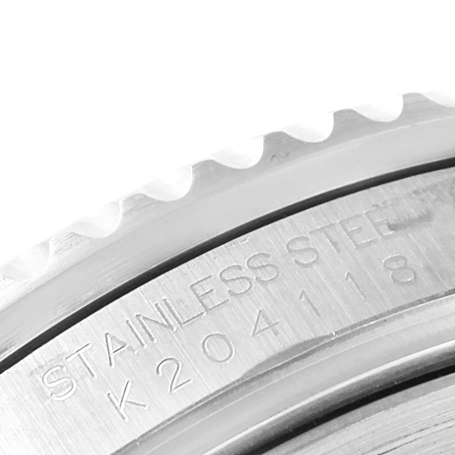 This close-up image shows the stainless steel bezel and engraving on the case of a Rolex GMT-Master 16710 Men's Stainless Steel Black Dial 16710 Men's Stainless Steel Black Dial watch.