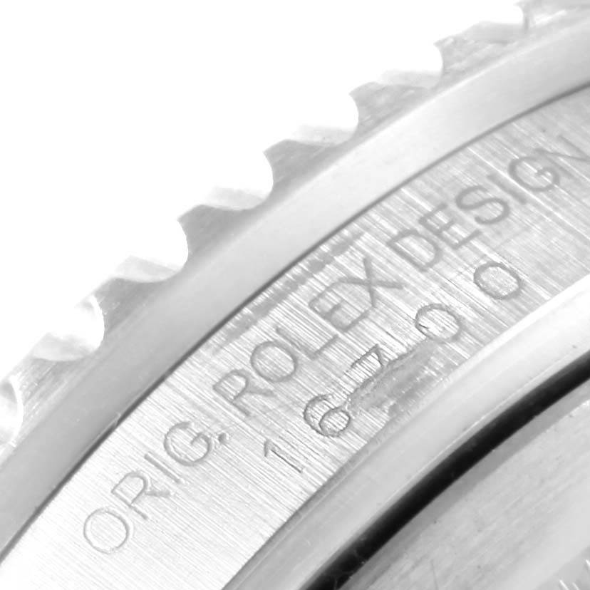 The image shows a close-up of the side engraving and bezel teeth of a Rolex GMT-Master 16700 Men's Stainless Steel Black Dial 16700 Men's Stainless Steel Black Dial watch.