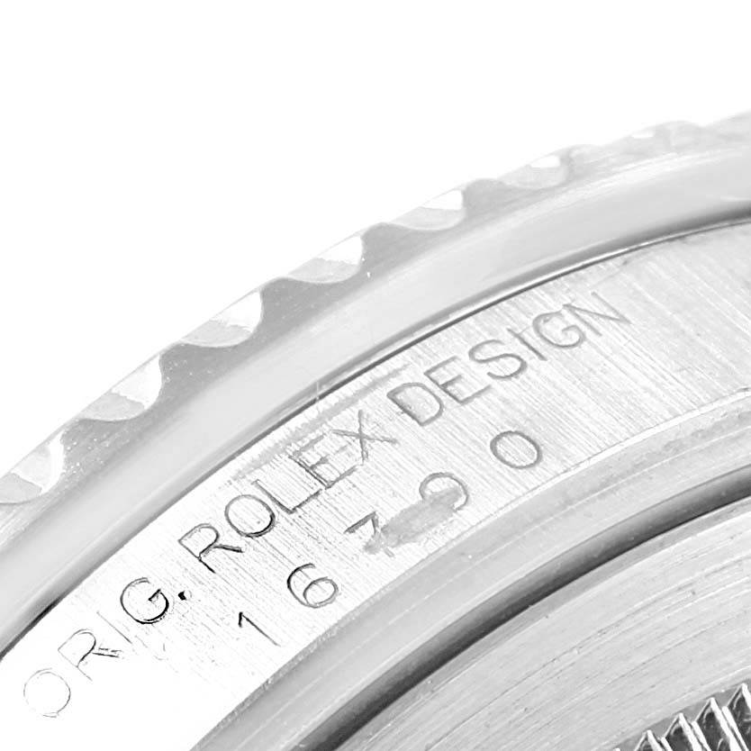 This image shows a close-up of the side of the watch case, featuring the engraved text "ROLEX DESIGN" and the model number of the Rolex GMT-Master 16700 Men's Stainless Steel Black Dial 16700 Men's Stainless Steel Black Dial.