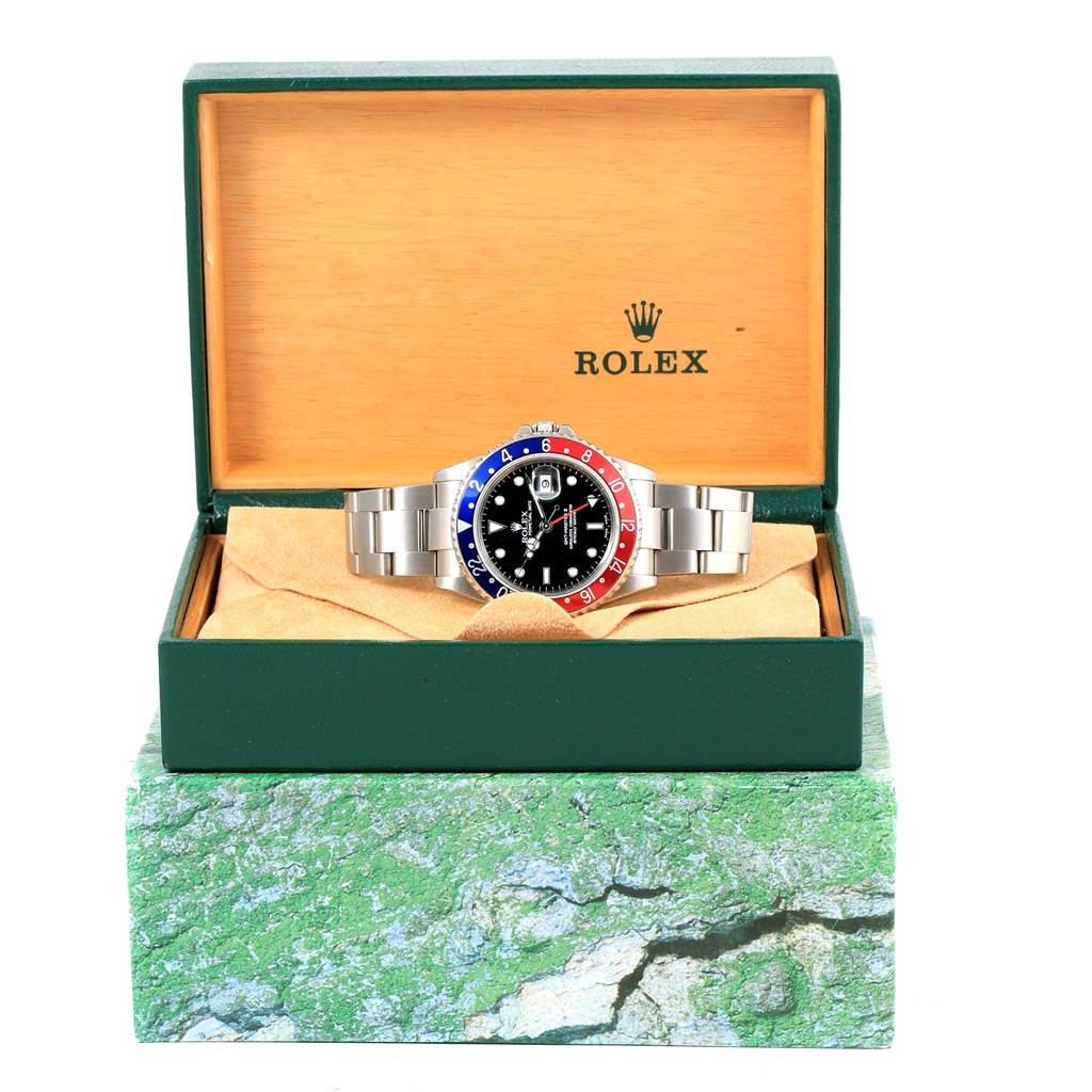 The Rolex GMT-Master 16710 Men
s Stainless Steel Black Dial 16710 Men
s Stainless Steel Black Dial watch is shown front-facing inside its open box.