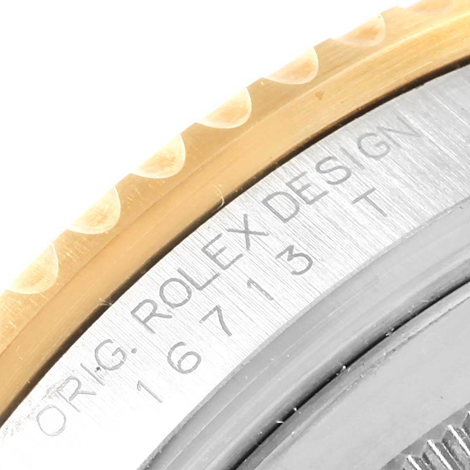 This close-up image shows the bezel and engraved case of a Rolex GMT-Master 16713 Men's Stainless Steel Brown Dial 16713 Men's Stainless Steel Brown Dial watch, displaying its model number and design details.
