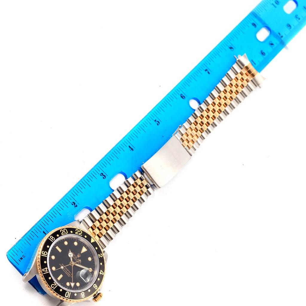 The image shows the face and bracelet of a Rolex GMT-Master 16713 Men's Stainless Steel Silver Dial 16713 Men's Stainless Steel Silver Dial watch, positioned next to a blue ruler for scale.