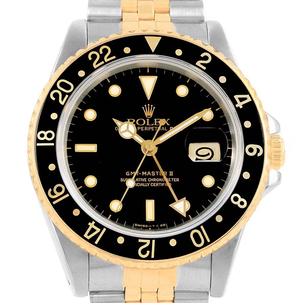 The image shows a front view of a Rolex GMT-Master 16713 Men's Stainless Steel Silver Dial 16713 Men's Stainless Steel Silver Dial II watch, displaying its black dial, gold and black bezel, and part of its two-tone bracelet.