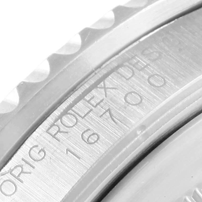 This image shows a close-up of the engraved bezel and case of a Rolex GMT-Master 16700 Men's Stainless Steel Black Dial 16700 Men's Stainless Steel Black Dial watch.
