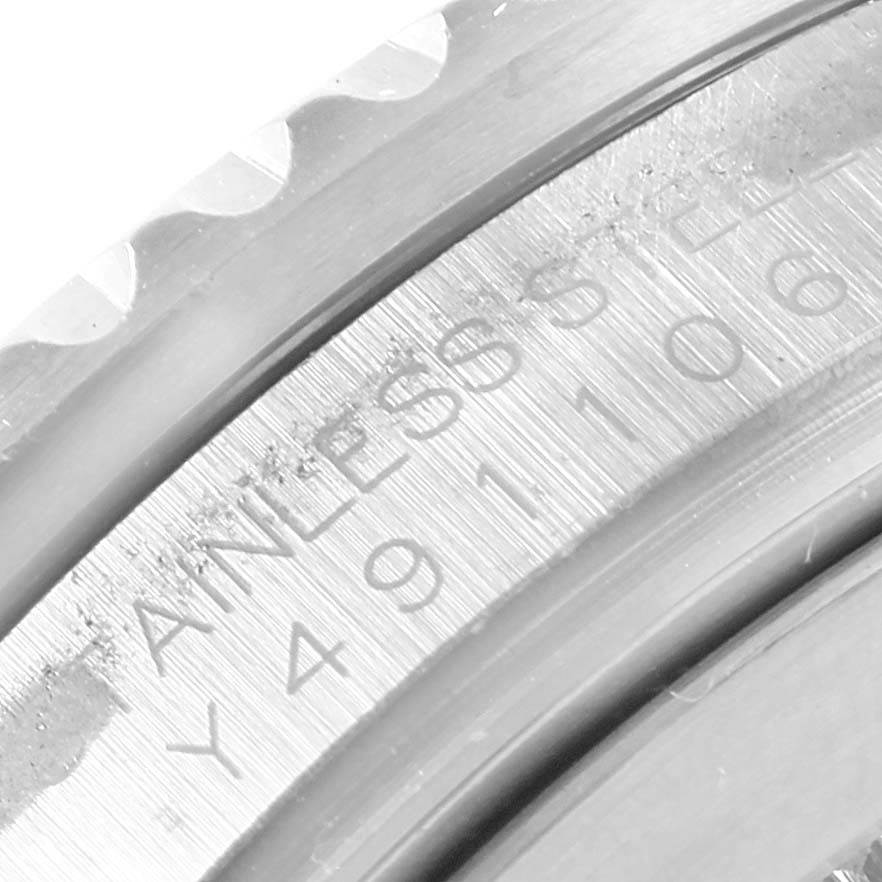 This close-up image shows the serial number engraving on the stainless steel case of a Rolex GMT-Master 16710 Men's Stainless Steel Black Dial 16710 Men's Stainless Steel Black Dial watch.