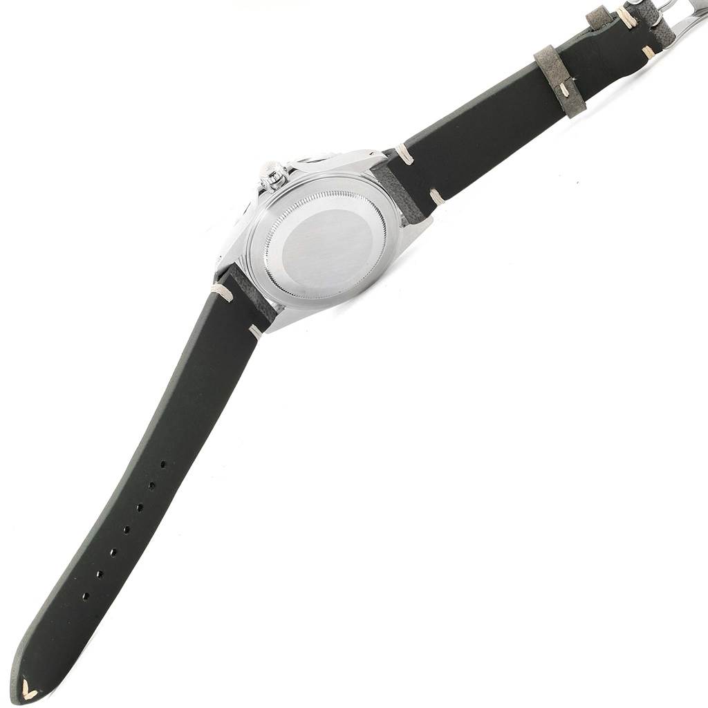 The image shows the back side of a Rolex GMT-Master 16710 Men's Stainless Steel Black Dial 16710 Men's Stainless Steel Black Dial watch along with its leather strap.