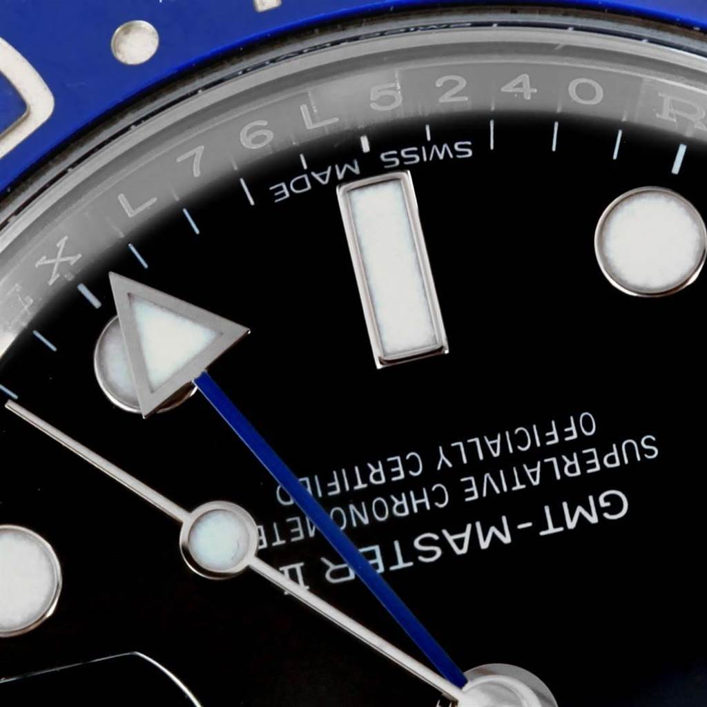 This close-up image of a Rolex GMT-Master 116710 Men's Stainless Steel Black Dial 116710 Men's Stainless Steel Black Dial watch shows parts of the dial, hour markers, and triangular and circular hands.