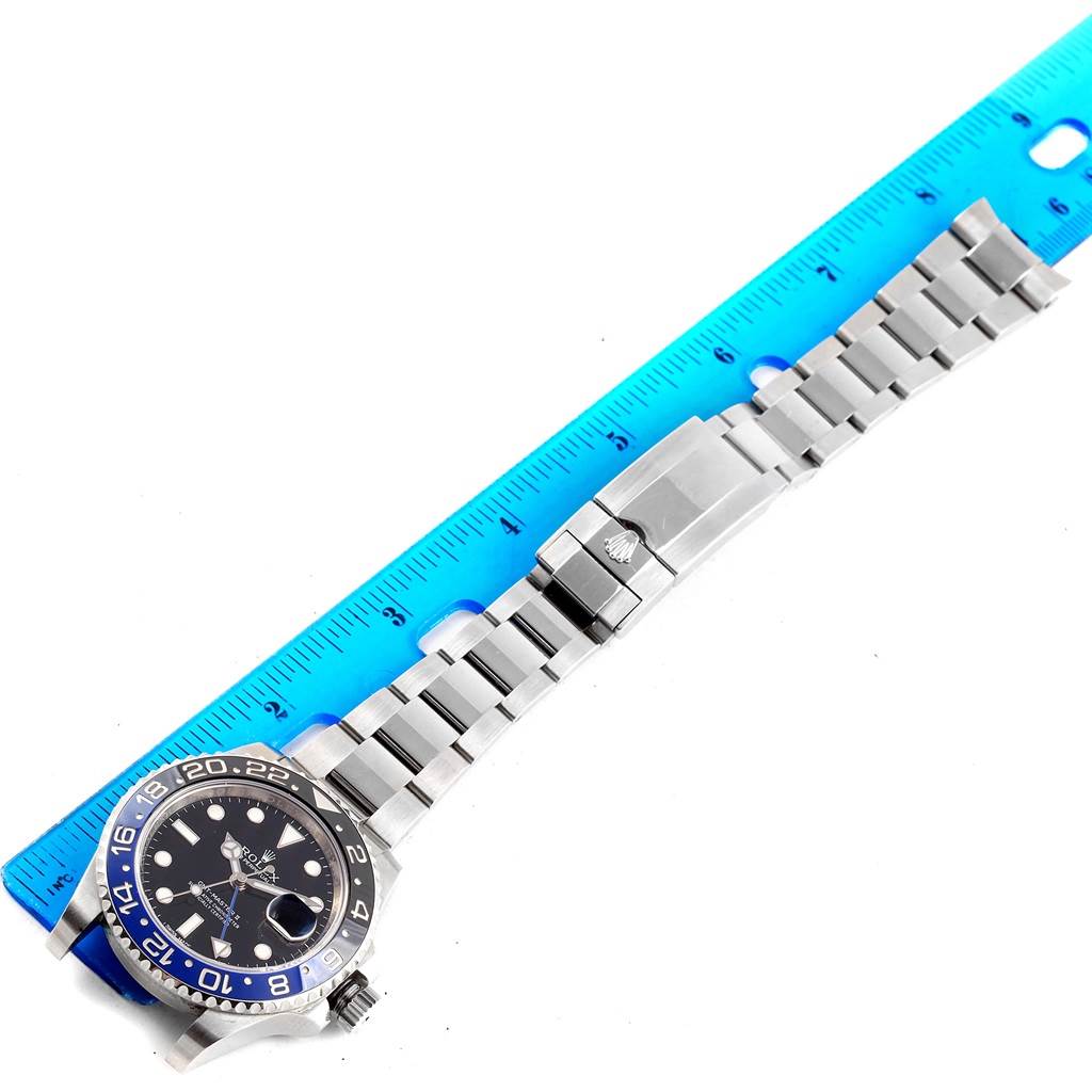 The image shows a Rolex GMT-Master 116710 Men's Stainless Steel Black Dial 116710 Men's Stainless Steel Black Dial watch with its face and bracelet in a flat lay position next to a ruler.