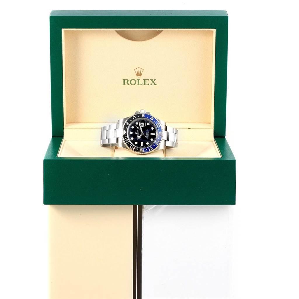 The Rolex GMT-Master 116710 Men's Stainless Steel Black Dial 116710 Men's Stainless Steel Black Dial watch is shown front-facing in its open green and beige display box.