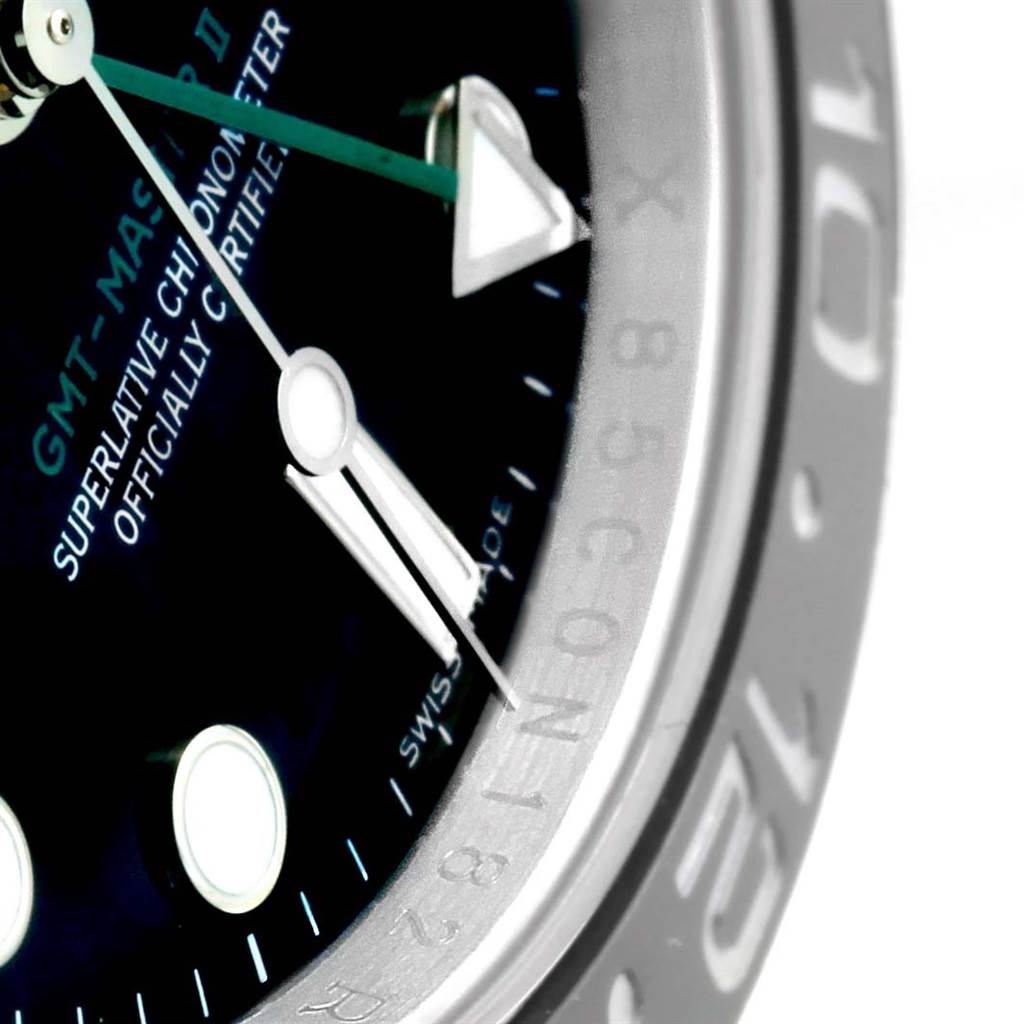 This image shows a zoomed-in angle of the Rolex GMT-Master 116710 Men
s Stainless Steel Black Dial 116710 Men
s Stainless Steel Black Dial II watch, highlighting the dial, hands, and the edge of the bezel.