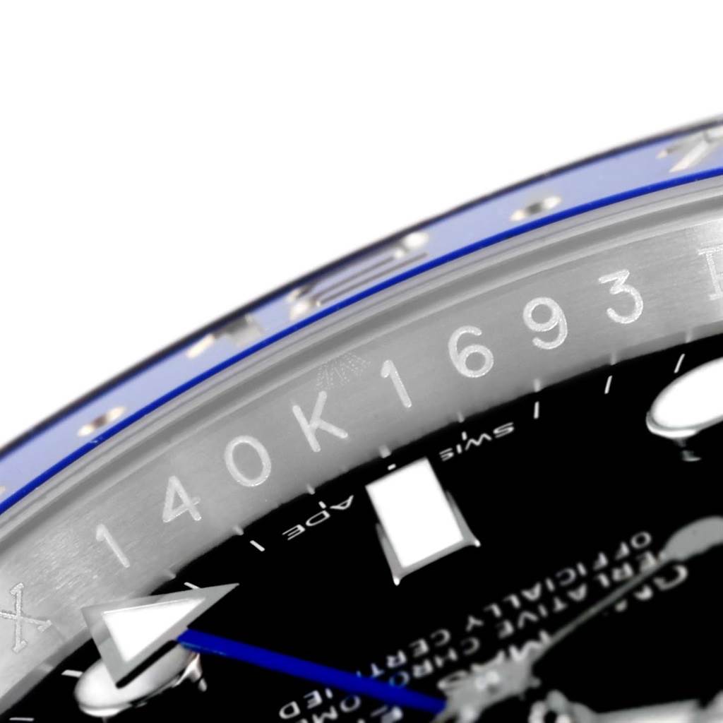 Close-up of the Rolex GMT-Master 116710 Men
s Stainless Steel Black Dial 116710 Men
s Stainless Steel Black Dial watch bezel and part of the dial, showing the numbers, markers, and an arrow hand.