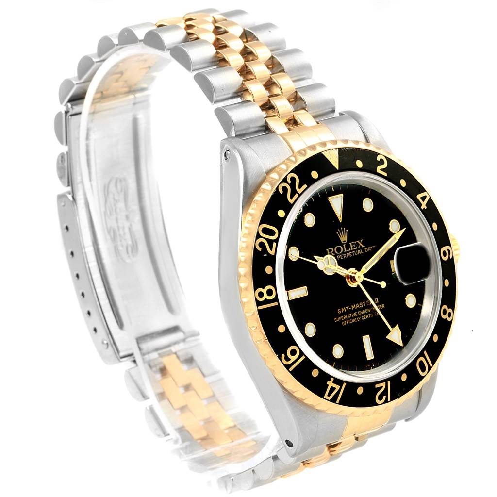 The image shows a three-quarter view of a Rolex GMT-Master 16713 Men's Stainless Steel Black Dial 16713 Men's Stainless Steel Black Dial watch highlighting its dual-tone bracelet and black bezel with a date magnifier.