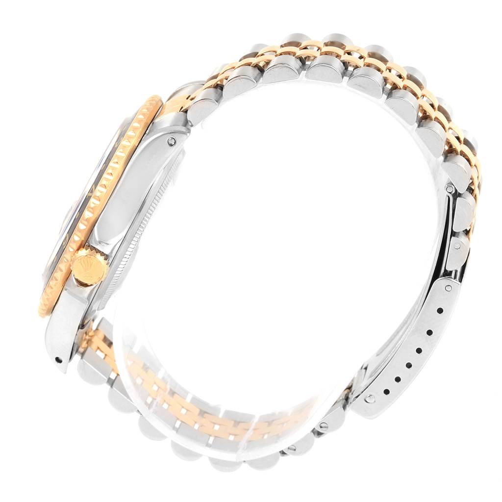 This image shows a side view of the Rolex GMT-Master 16713 Men's Stainless Steel Black Dial 16713 Men's Stainless Steel Black Dial watch, highlighting its crown, bezel, and two-tone bracelet.