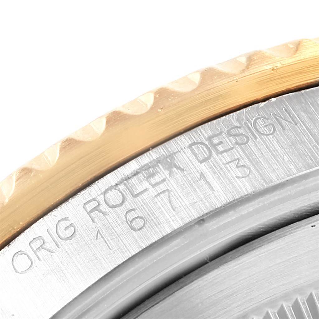 This close-up image shows the edge of the bezel and engraved case back of a Rolex GMT-Master 16713 Men's Stainless Steel Black Dial 16713 Men's Stainless Steel Black Dial watch.