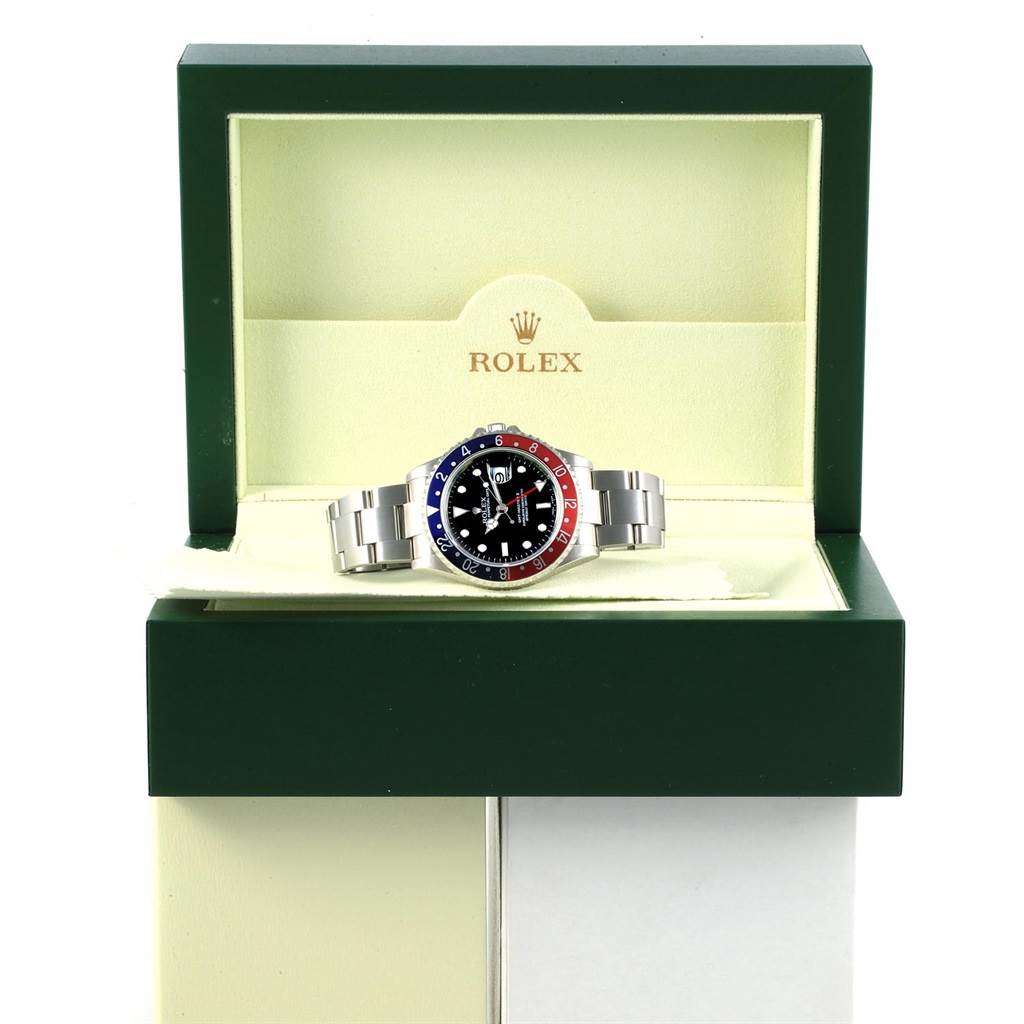 The image shows a frontal view of a Rolex GMT-Master 16710 Men's Stainless Steel Black Dial 16710 Men's Stainless Steel Black Dial watch featuring a stainless steel bracelet and a bi-color bezel, inside its branded box.