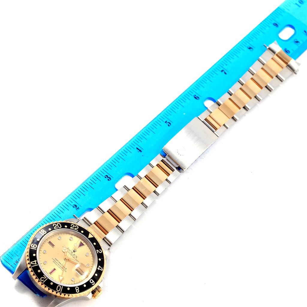 The image shows a Rolex GMT-Master 16713 Men's Stainless Steel Champagne Dial 16713 Men's Stainless Steel Champagne Dial watch lying flat next to a blue ruler, displaying the face, bezel, and bracelet.