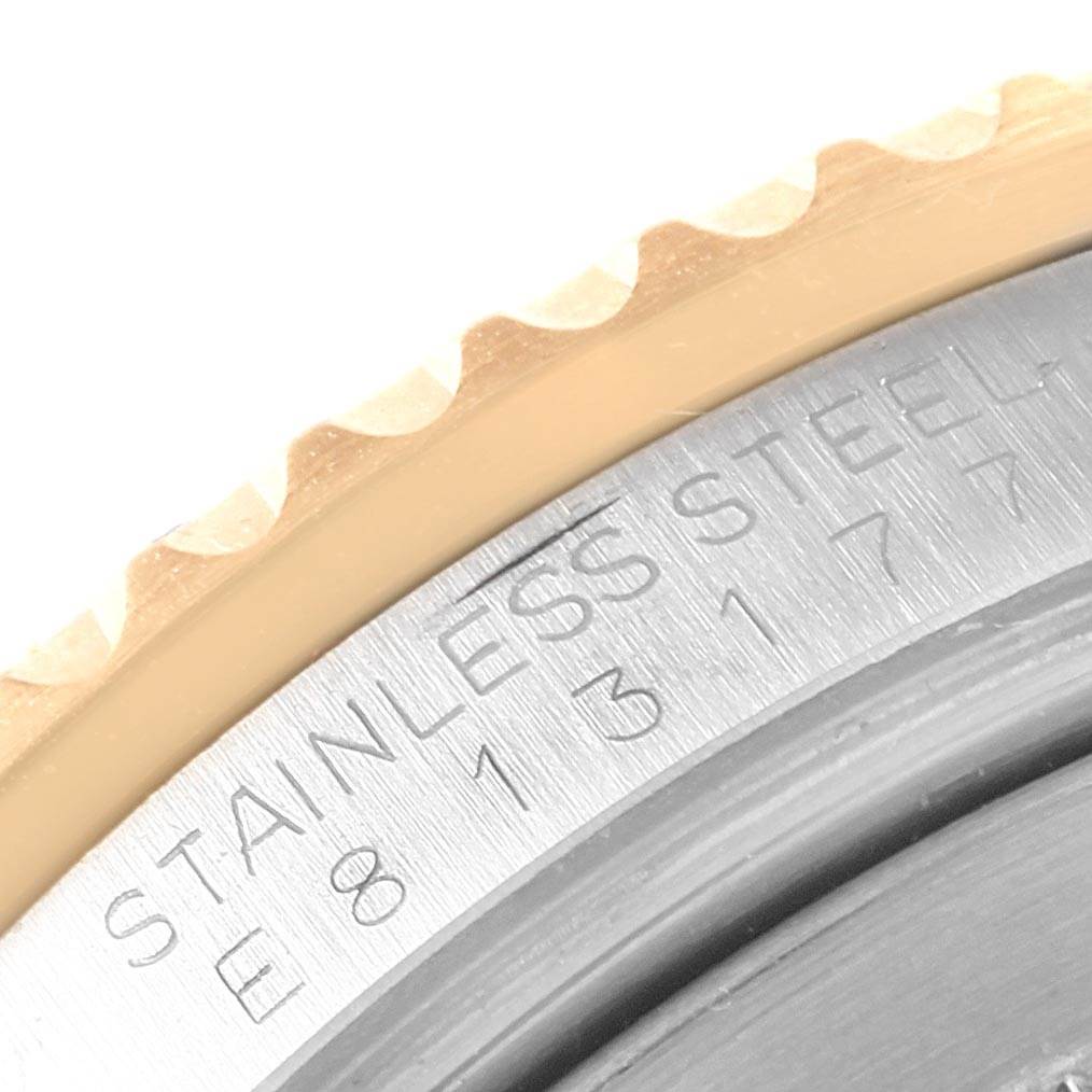 This close-up image shows part of the bezel and the stainless steel case back of a Rolex GMT-Master 16713 Men's Stainless Steel Champagne Dial 16713 Men's Stainless Steel Champagne Dial watch.