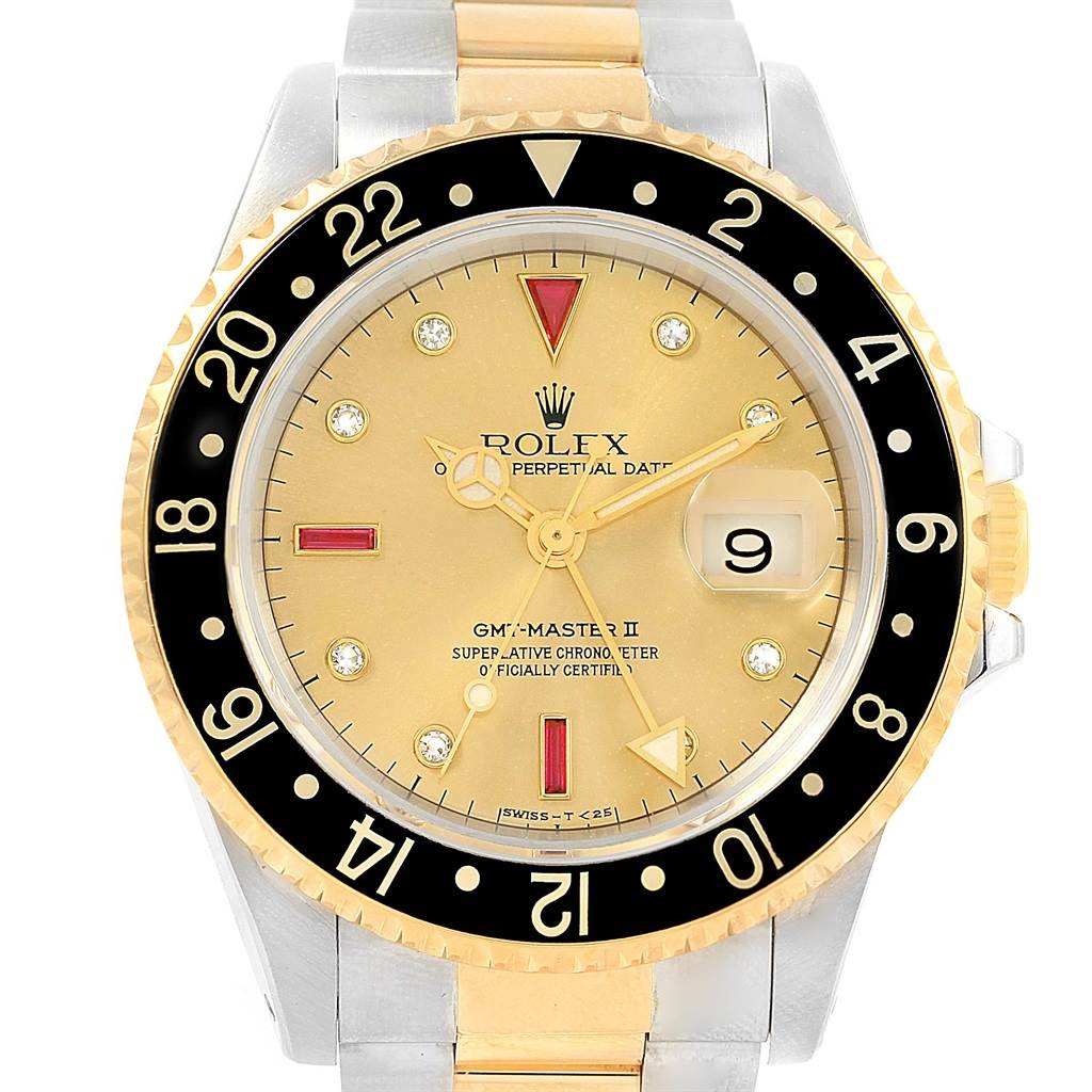 The image shows a front view of the Rolex GMT-Master 16713 Men's Stainless Steel Champagne Dial 16713 Men's Stainless Steel Champagne Dial II watch, featuring a black bezel, gold dial, and two-tone bracelet.