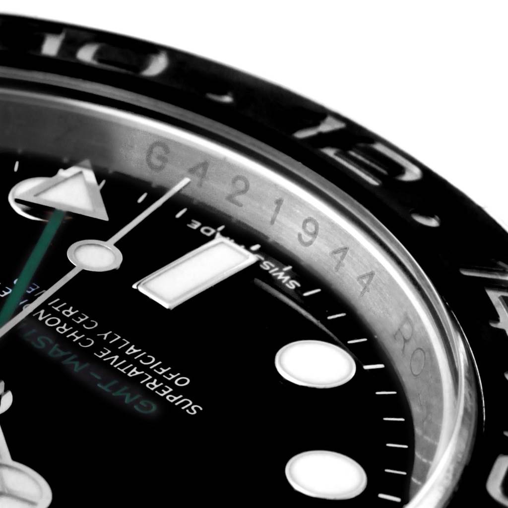 This close-up of a Rolex GMT-Master 116710 Men's Stainless Steel Black Dial 116710 Men's Stainless Steel Black Dial shows part of the dial, hands, and bezel.