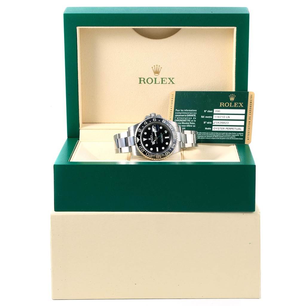 The Rolex GMT-Master 116710 Men's Stainless Steel Black Dial 116710 Men's Stainless Steel Black Dial watch is shown from a front angle inside its box with a warranty card displayed.