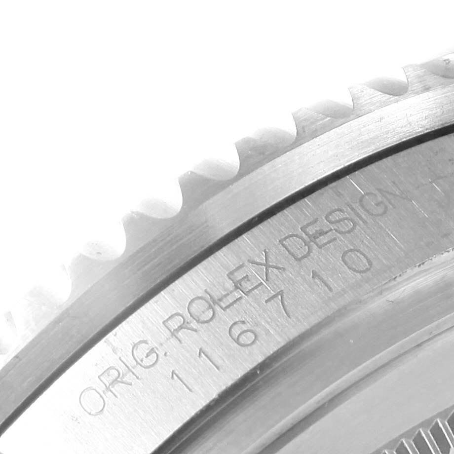 This image shows a close-up of the Rolex GMT-Master 116710 Men's Stainless Steel Black Dial 116710 Men's Stainless Steel Black Dial's case and engraved model number on the watch bezel.