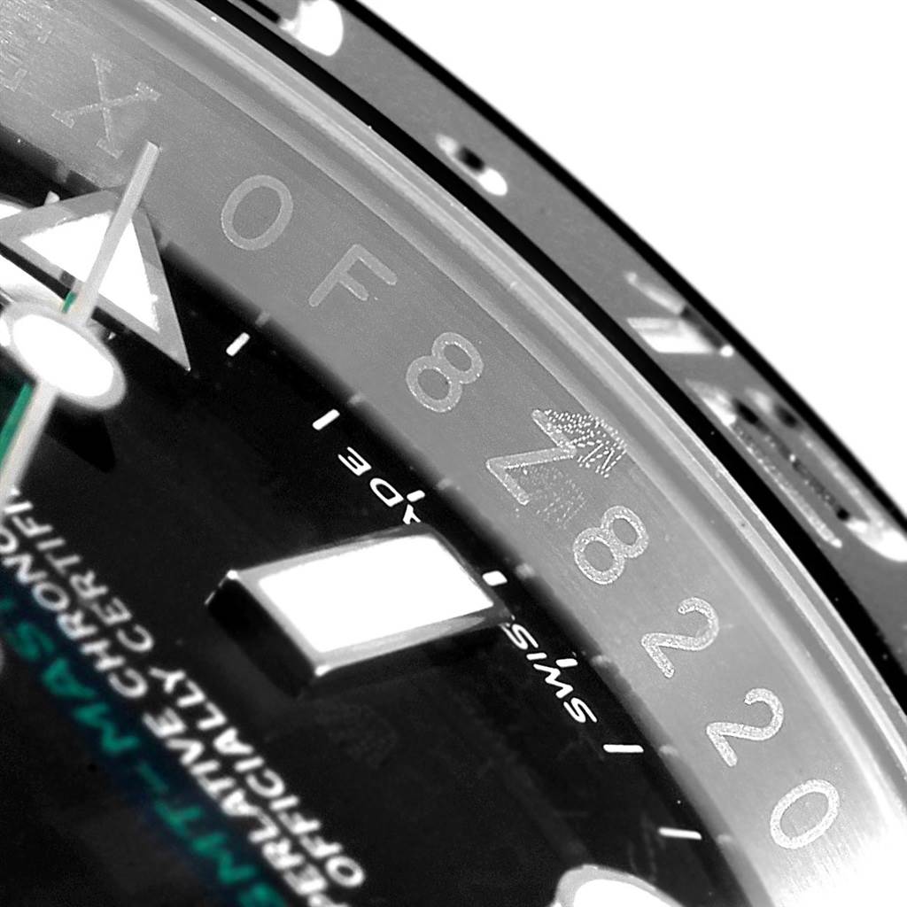 The image shows a close-up of the dial and bezel edge details of a Rolex GMT-Master 116710 Men's Stainless Steel Black Dial 116710 Men's Stainless Steel Black Dial watch.