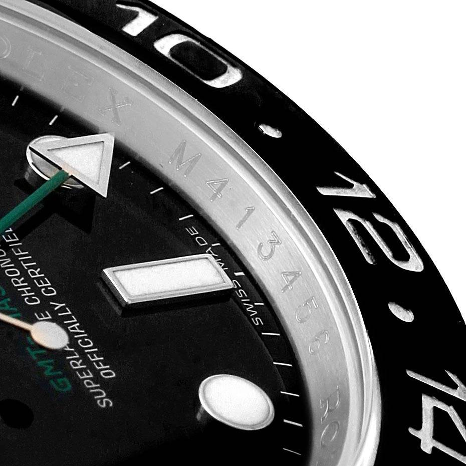 The image shows a close-up of the bezel, part of the dial, and hands of a Rolex GMT-Master 116710 Men
s Stainless Steel Black Dial 116710 Men
s Stainless Steel Black Dial watch.