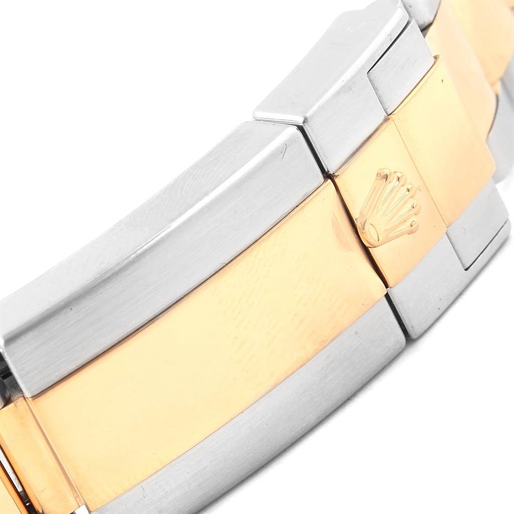 This image shows a close-up of the bracelet clasp of a Rolex GMT-Master 116713 Men
s Stainless Steel Black Dial 116713 Men
s Stainless Steel Black Dial, highlighting the two-tone metal and the Rolex logo.