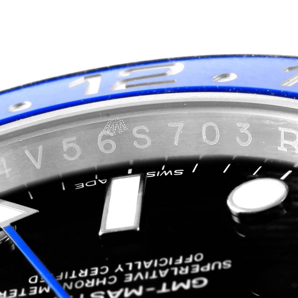 The image shows a close-up angle of the Rolex GMT-Master 116710 Men's Stainless Steel Black Dial 116710 Men's Stainless Steel Black Dial watch's bezel, dial, and part of the rehaut with engravings.