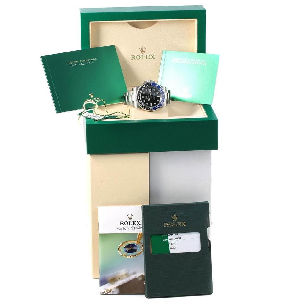 The Rolex GMT-Master 116710 Men's Stainless Steel Black Dial 116710 Men's Stainless Steel Black Dial watch is shown from the front in its box, accompanied by manuals and service booklets.