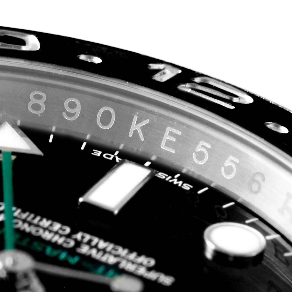 This close-up photo of the Rolex GMT-Master 116710 Men's Stainless Steel Black Dial 116710 Men's Stainless Steel Black Dial watch shows the bezel edge, part of the dial, and the serial number.