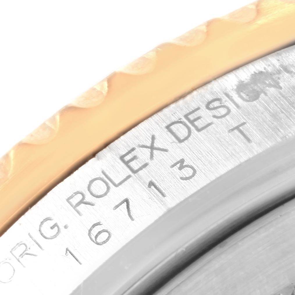 Close-up of the Rolex GMT-Master 16713 Men's Stainless Steel Black Dial 16713 Men's Stainless Steel Black Dial watch showing part of the bezel and case with model number 16713.