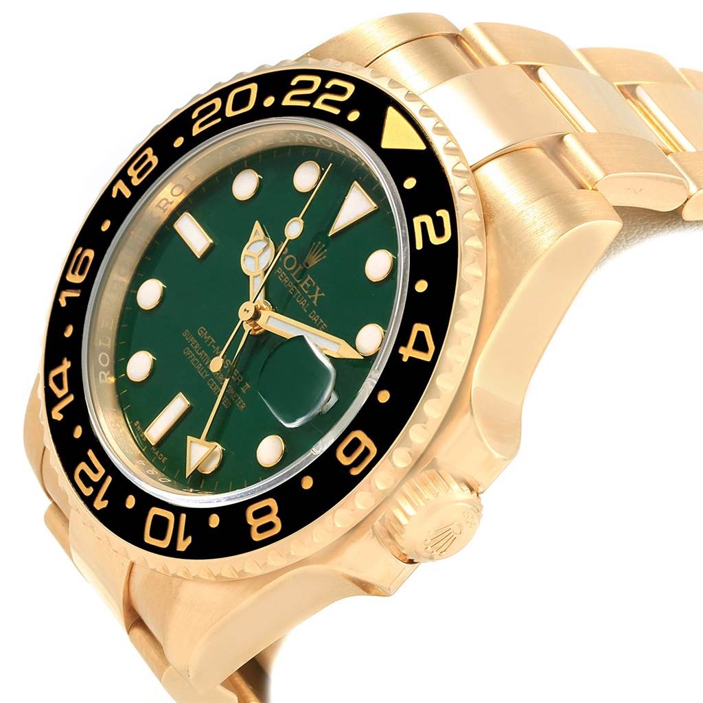 This image shows a close-up, angled view of a Rolex GMT-Master 116718 Men's Yellow Gold Green Dial 116718 Men's Yellow Gold Green Dial watch, highlighting the green dial, bezel, and part of the gold bracelet.