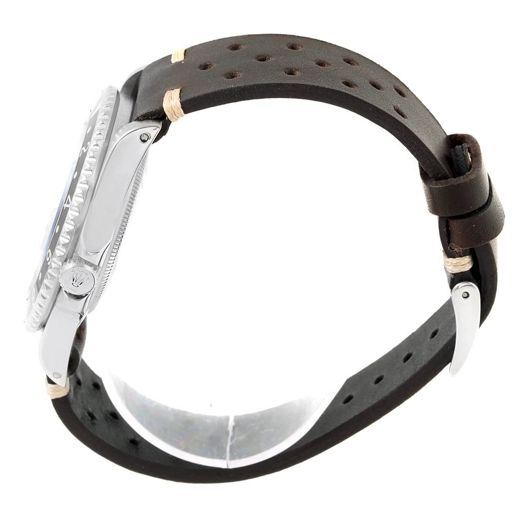 The image shows a side view of the Rolex GMT-Master 16700 Men's Stainless Steel Black Dial 16700 Men's Stainless Steel Black Dial watch highlighting its bezel and crown, with a perforated leather strap.