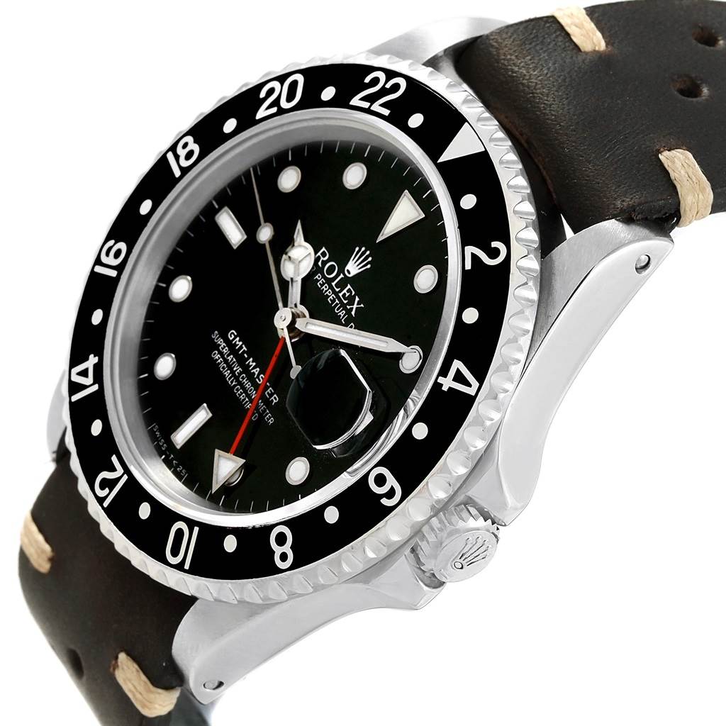 The Rolex GMT-Master 16700 Men's Stainless Steel Black Dial 16700 Men's Stainless Steel Black Dial model watch is shown at an angle highlighting its black dial, bezel, crown, and leather strap.