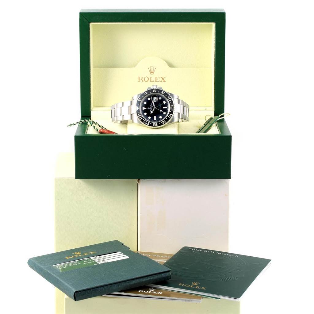 The Rolex GMT-Master 116710 Men's Stainless Steel Black Dial 116710 Men's Stainless Steel Black Dial watch is displayed front-on in its original box, alongside accompanying booklets and tags.