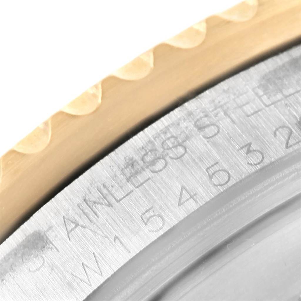 This close-up image shows the edge of the bezel and the serial number of a Rolex GMT-Master 16713 Men's Stainless Steel Champagne Dial 16713 Men's Stainless Steel Champagne Dial watch.