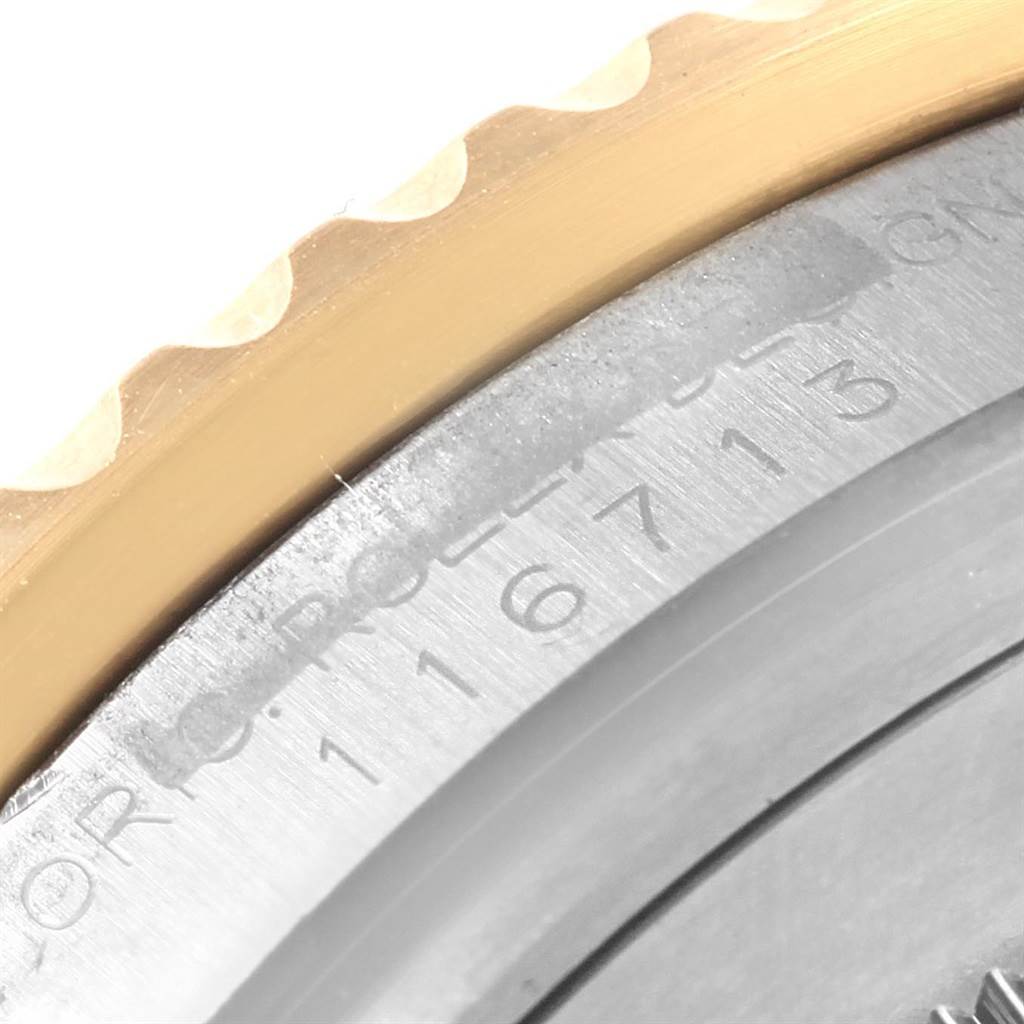 This image shows a close-up of the bezel and part of the case back, with serial number engraving, of a Rolex GMT-Master 116713 Men
s Stainless Steel Black Dial 116713 Men
s Stainless Steel Black Dial watch.