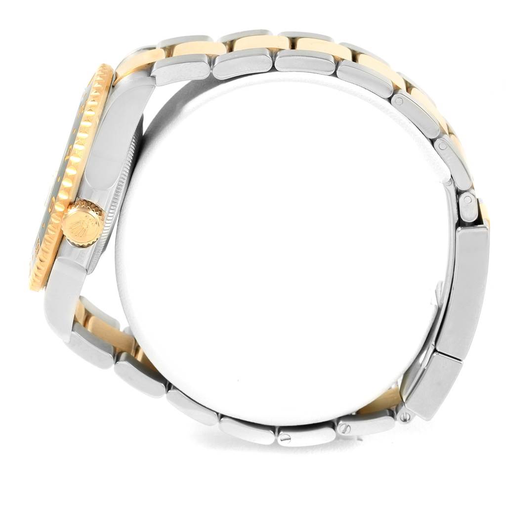 The image shows a side view of the Rolex GMT-Master 116713 Men
s Stainless Steel Black Dial 116713 Men
s Stainless Steel Black Dial watch, highlighting its two-tone bracelet and crown.