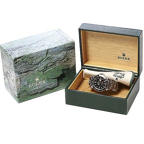 The Rolex GMT-Master 16710 Men's Stainless Steel Black Dial 16710 Men's Stainless Steel Black Dial watch is shown in its open box, with the box lid also visible on the left.