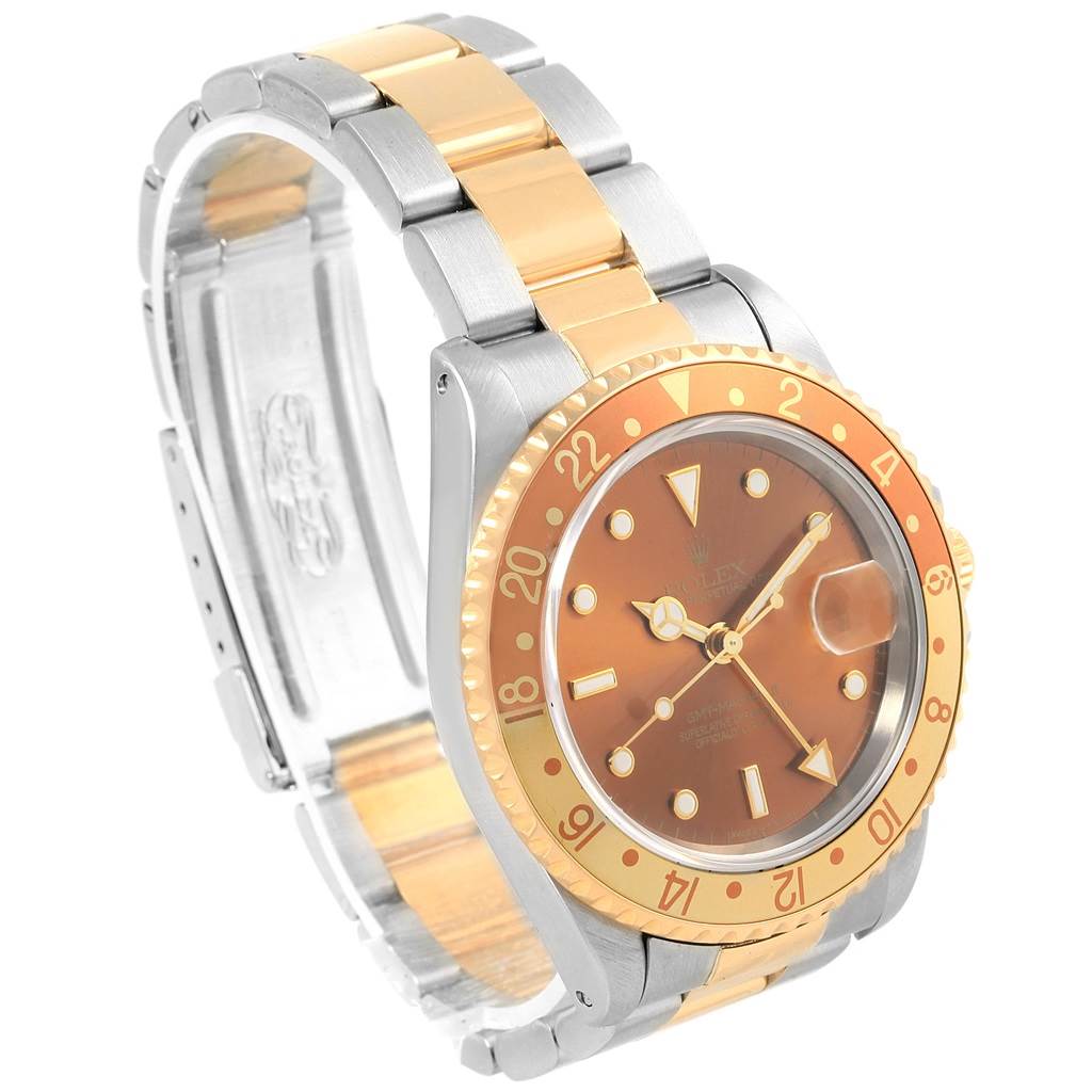 The Rolex GMT-Master 16713 Men's Stainless Steel Brown Dial 16713 Men's Stainless Steel Brown Dial watch is shown from a three-quarter angle, highlighting the face, bezel, and two-tone bracelet.