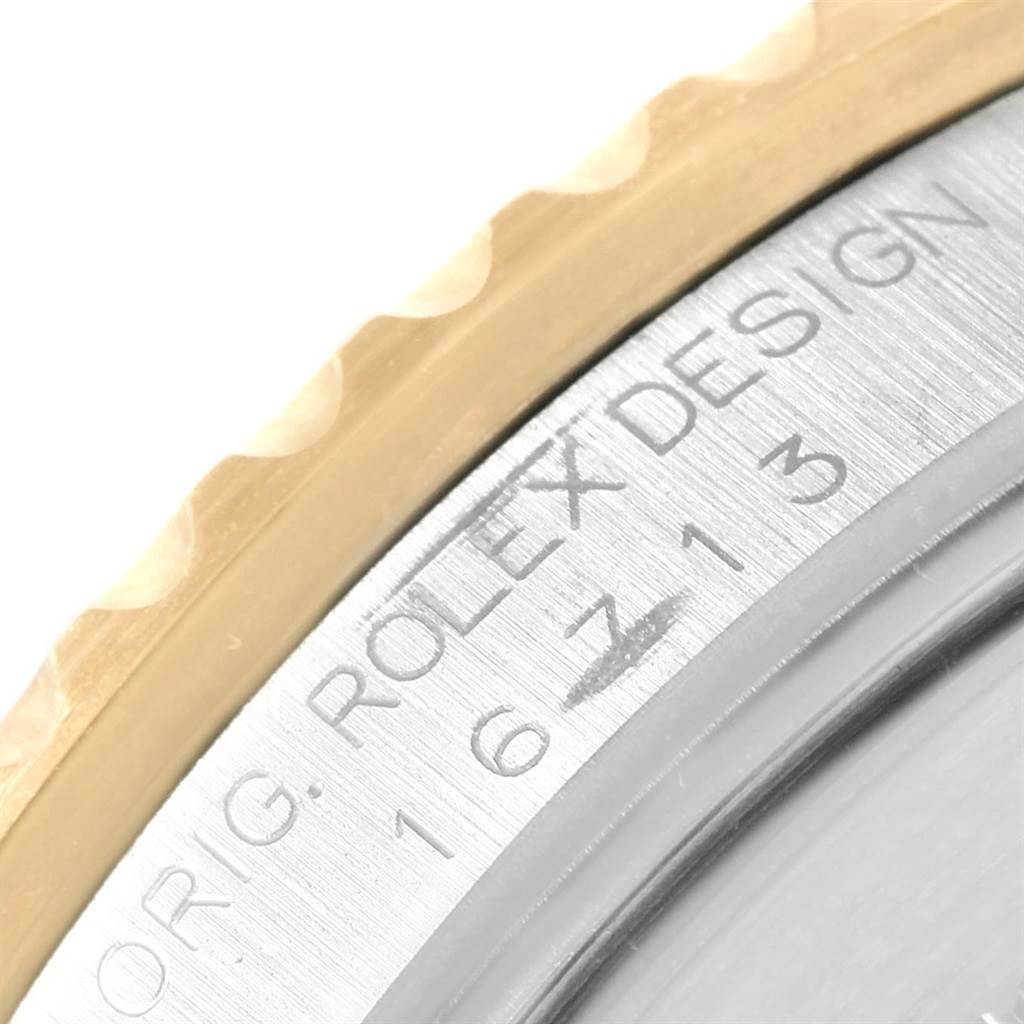 The image shows a close-up of the bezel and engraved edge of a Rolex GMT-Master 16713 Men's Stainless Steel Brown Dial 16713 Men's Stainless Steel Brown Dial watch.