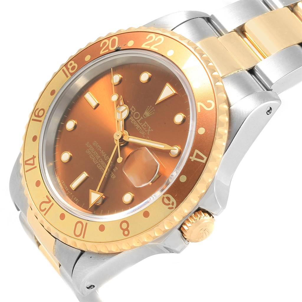The Rolex GMT-Master 16713 Men's Stainless Steel Brown Dial 16713 Men's Stainless Steel Brown Dial watch is shown from an angled close-up, highlighting its bezel, dial, bracelet, and crown.